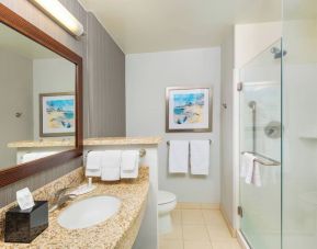 Guest bathroom with shower at Courtyard By Marriott Santa Ana Orange County.