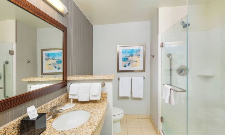 Guest bathroom with shower at Courtyard By Marriott Santa Ana Orange County.