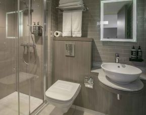 Guest bathroom with shower at Best Western Plus Vauxhall Hotel.