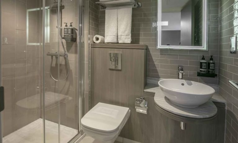 Guest bathroom with shower at Best Western Plus Vauxhall Hotel.