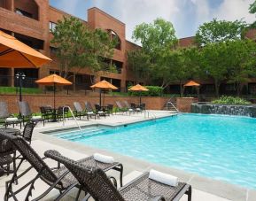 Refreshing outdoor pool with plenty of sun loungers at DoubleTree Suites By Hilton Hotel Charlotte - SouthPark.