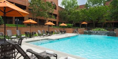 Refreshing outdoor pool with plenty of sun loungers at DoubleTree Suites By Hilton Hotel Charlotte - SouthPark.