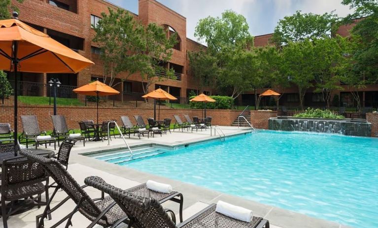 Refreshing outdoor pool with plenty of sun loungers at DoubleTree Suites By Hilton Hotel Charlotte - SouthPark.