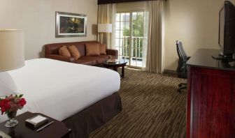 Day use room with sofa, work desk and balcony at DoubleTree Raleigh Durham Airport At Research Triangle Park.