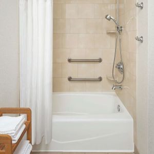 Guest bathroom with shower and tub at DoubleTree Raleigh Durham Airport At Research Triangle Park.