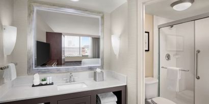 Guest bathroom with shower at Embassy Suites By Hilton Fort Worth Downtown.

