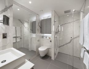 Guest bathroom with shower and guest bathroom at Tower Suites Hotel by Blue Orchid.