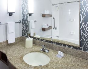 Guest bathroom with shower and tub at Hilton Garden Inn Sacramento/South Natomas.