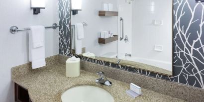 Guest bathroom with shower and tub at Hilton Garden Inn Sacramento/South Natomas.