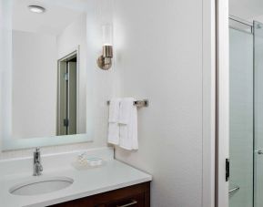 Guest bathroom with shower at Homewood Suites By Hilton Nashville.