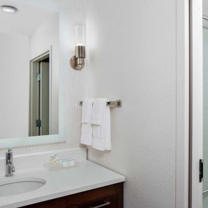 Guest bathroom with shower at Homewood Suites By Hilton Nashville.