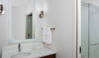 Guest bathroom with shower at Homewood Suites By Hilton Nashville.