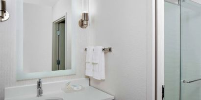 Guest bathroom with shower at Homewood Suites By Hilton Nashville.