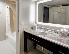 Guest bathroom with shower and tub at Homewood Suites By Hilton San Jose Airport-Silicon Valley.