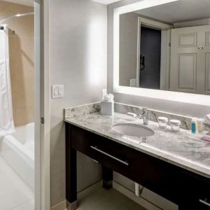 Guest bathroom with shower and tub at Homewood Suites By Hilton San Jose Airport-Silicon Valley.