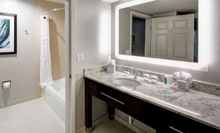 Guest bathroom with shower and tub at Homewood Suites By Hilton San Jose Airport-Silicon Valley.