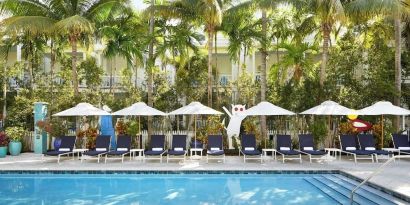 Outdoor pool with loungers at Parrot Key Hotel & Villas.