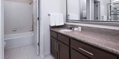 Guest bathroom with shower and tub at Residence Inn By Marriott Provo.