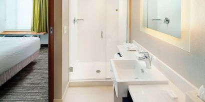 Guest bathroom with shower at Springhill Suites Carle Place.