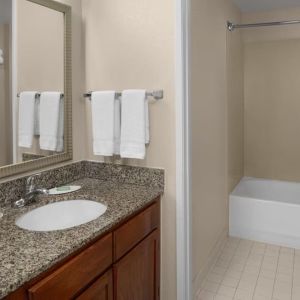 Guest bathroom with shower and tub at Residence Inn By Marriott San Diego Downtown.