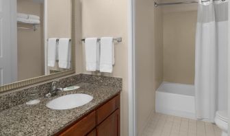 Guest bathroom with shower and tub at Residence Inn By Marriott San Diego Downtown.