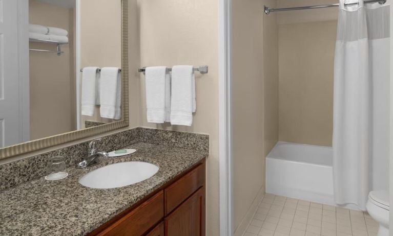 Guest bathroom with shower and tub at Residence Inn By Marriott San Diego Downtown.