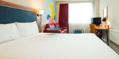 Day use room with work desk and sofa at ibis Styles Birmingham NEC.