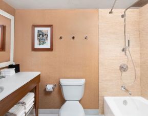 Guest bathroom with shower and tub at The Westin Crystal City Reagan National Airport.