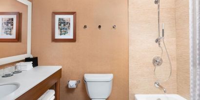 Guest bathroom with shower and tub at The Westin Crystal City Reagan National Airport.