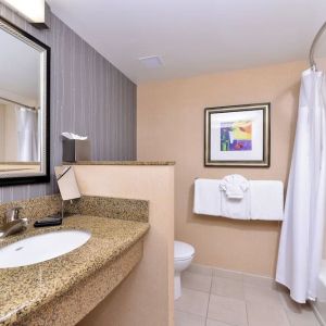 Guest bathroom with shower and tub at Courtyard By Marriott Boise West/Meridian.