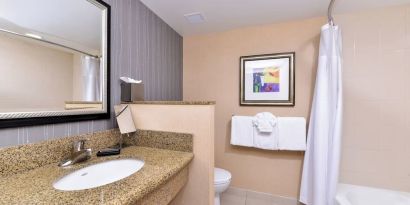 Guest bathroom with shower and tub at Courtyard By Marriott Boise West/Meridian.