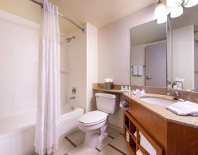 Guest bathroom with shower and tub at Fairfield Inn By Marriott Las Vegas Convention Center.
