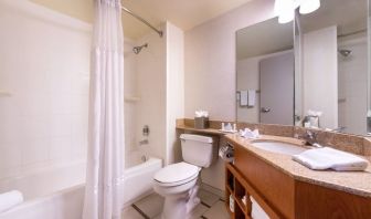 Guest bathroom with shower and tub at Fairfield Inn By Marriott Las Vegas Convention Center.
