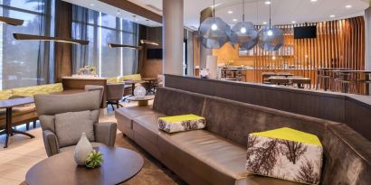 Lobby and coworking lounge at SpringHill Suites By Marriott Irvine John Wayne Airport/Orange County.