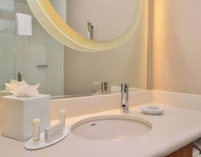 Guest bathroom with shower at SpringHill Suites By Marriott Irvine John Wayne Airport/Orange County.