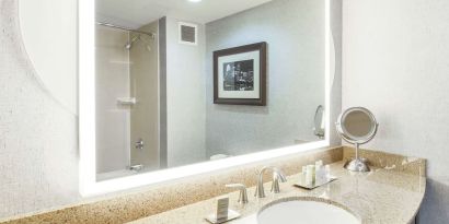 Guest bathroom with shower at DoubleTree By Hilton Austin University Area.