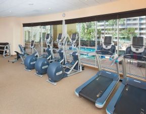 Fitness facility with a view of the pool at Hilton Garden Inn Burbank Downtown.