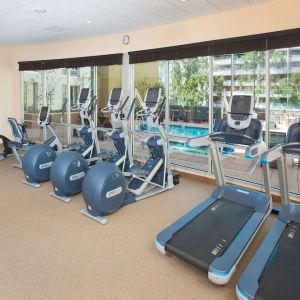 Fitness facility with a view of the pool at Hilton Garden Inn Burbank Downtown.