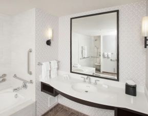 Guest bathroom with shower and tub at Hilton Garden Inn Burbank Downtown.