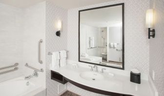 Guest bathroom with shower and tub at Hilton Garden Inn Burbank Downtown.