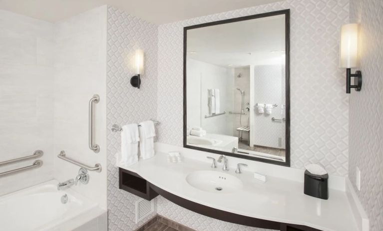 Guest bathroom with shower and tub at Hilton Garden Inn Burbank Downtown.