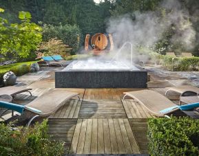 Relaxing outdoor jacuzzi with lounge chairs at Alexander House Hotel And Utopia Spa Hotel.