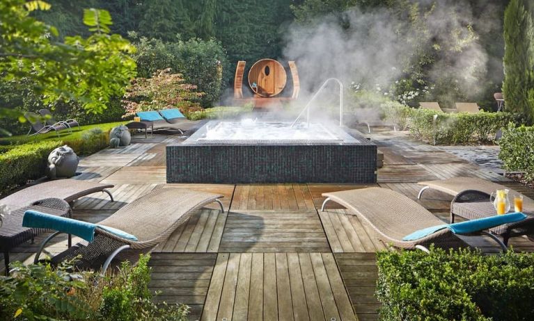 Relaxing outdoor jacuzzi with lounge chairs at Alexander House Hotel And Utopia Spa Hotel.