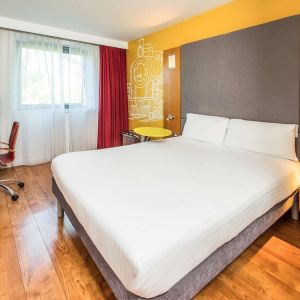 Bright and spacious day use room with king bed and work desk at Ibis Styles Crewe.