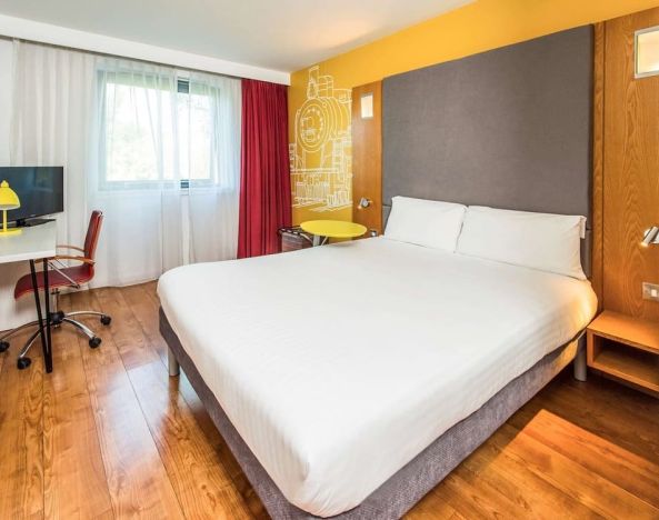 Bright and spacious day use room with king bed and work desk at Ibis Styles Crewe.