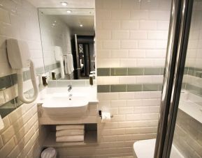 Guest bathroom with shower and free toiletries at Aparthotel Best Western Plus London Croydon.