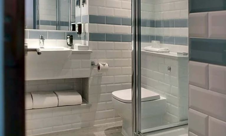 Private guest bathroom with shower at Aparthotel Best Western Plus London Croydon.