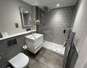 Private guest bathroom with shower and free toiletries at Best Western Plus Dover Marina Hotel & Spa. 