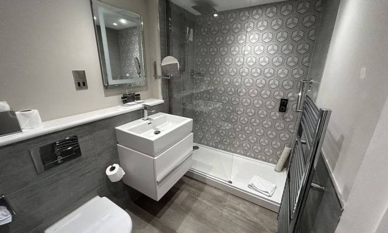 Private guest bathroom with shower and free toiletries at Best Western Plus Dover Marina Hotel & Spa. 