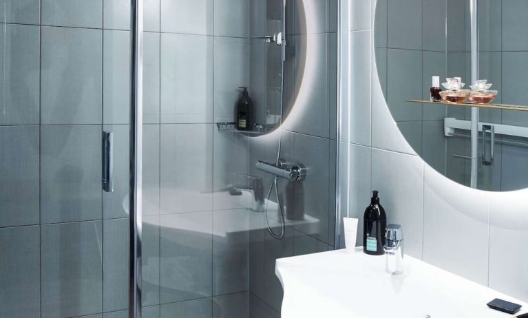 Private guest bathroom with shower and free toiletries at Adagio Aparthotel Edinburgh Royal Mile.
